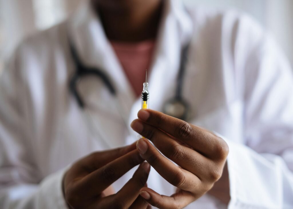 Protocols Close-up of a healthcare professional holding a syringe, symbolizing medical care and vaccination.